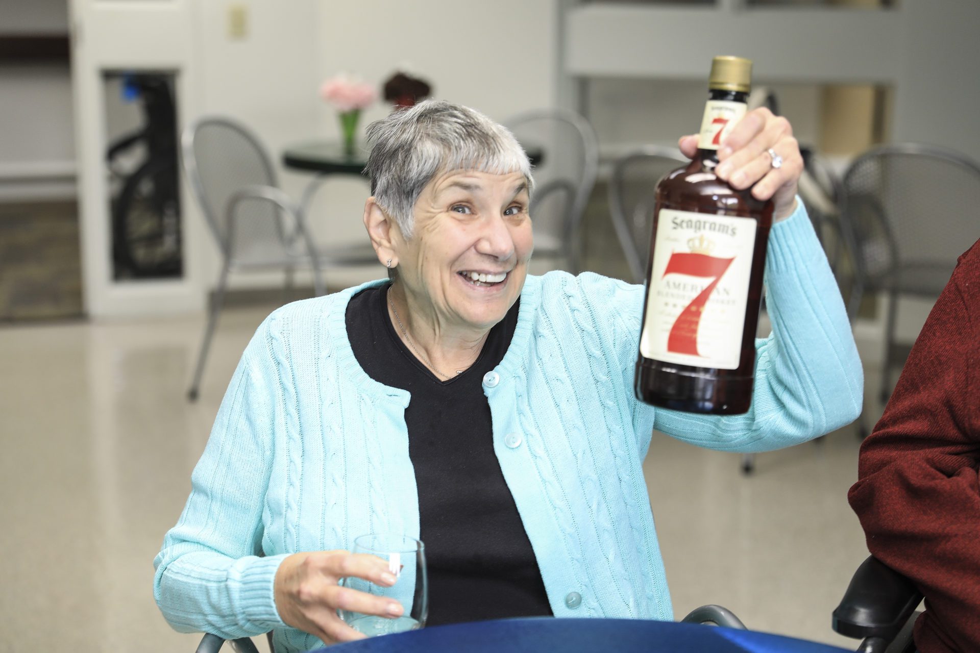 elderly woman having a drink